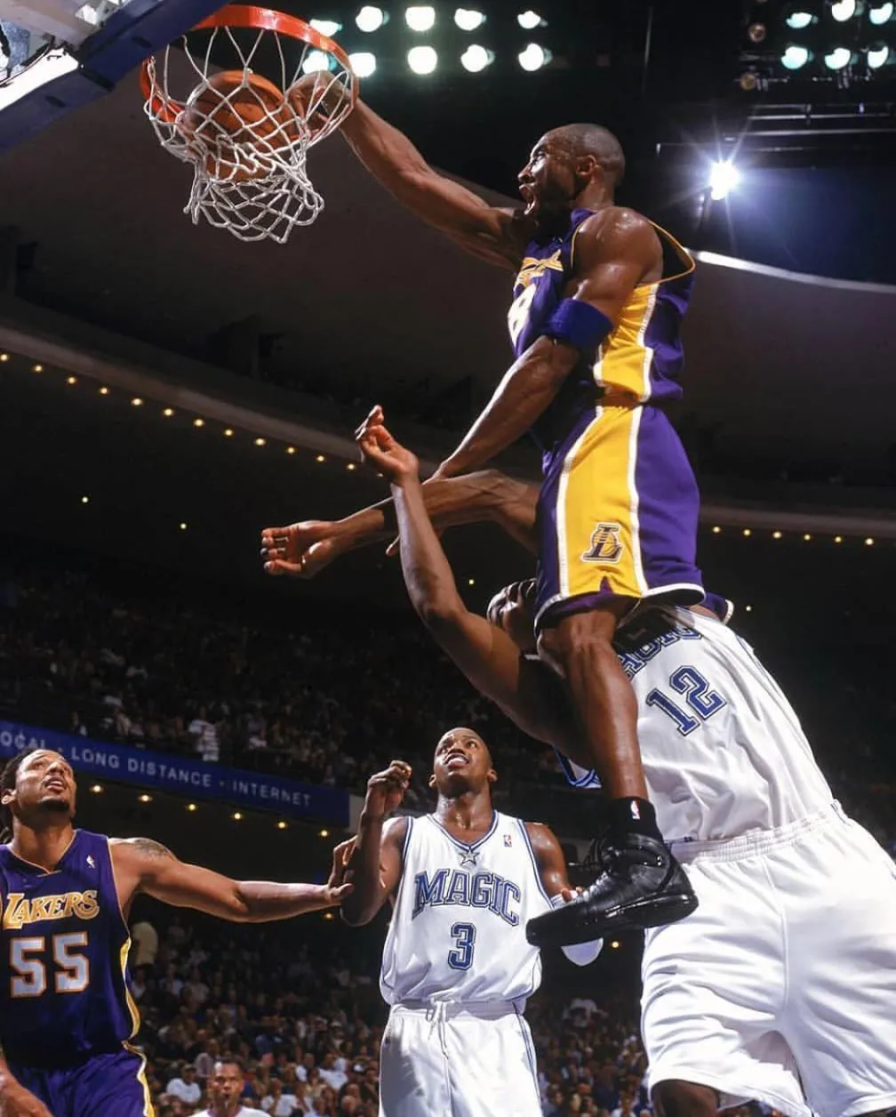 Kobe Bryant of the Los Angeles Lakers dunks over Dwight Howard of the Orlando Magic during a 2004 NBA game.